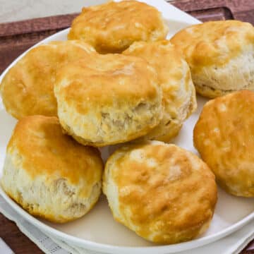 Overhead view of a plate with several biscuits on it.