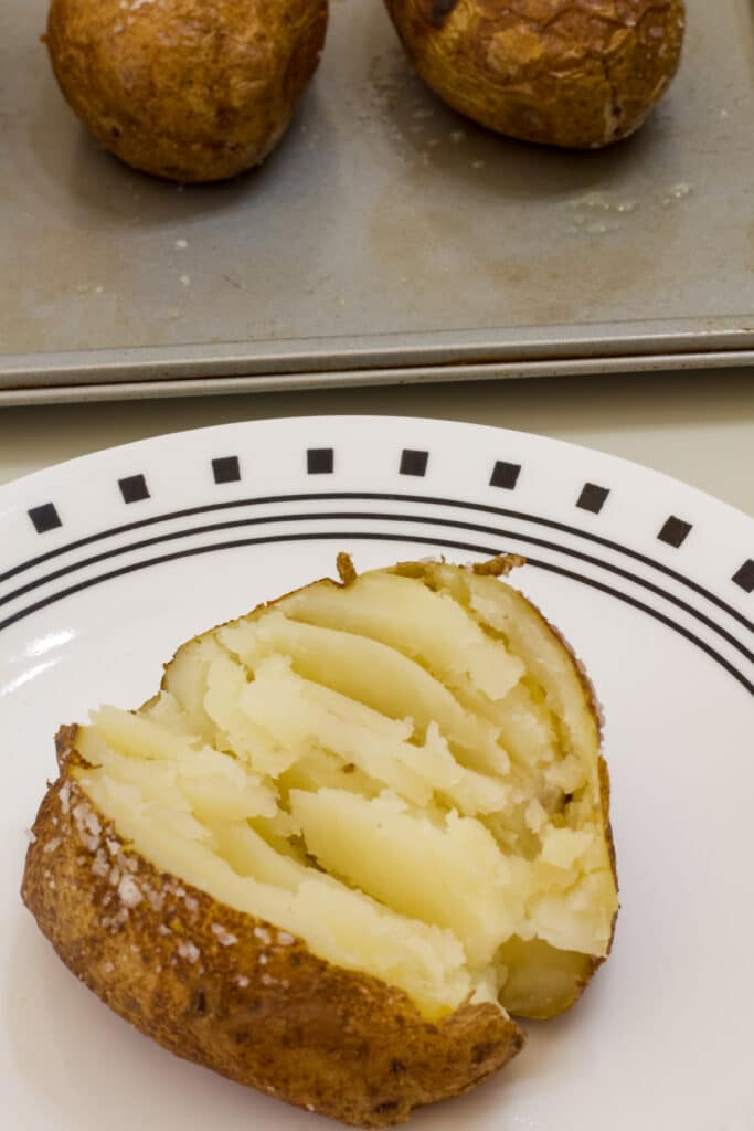 One plain baked potato that was baked in the oven without foil.
