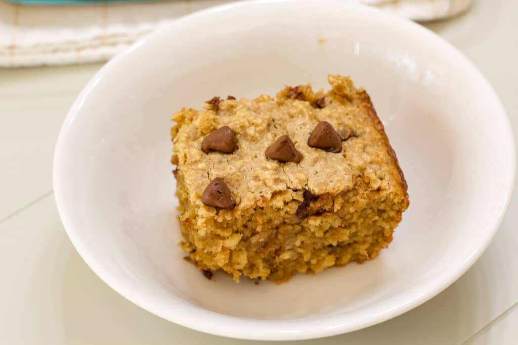 One serving of chocolate chip baked oats in a white bowl.