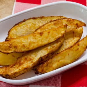 Easy 20 Minute Air Fryer Potato Wedges on a white plate, this is the feature image for this post.