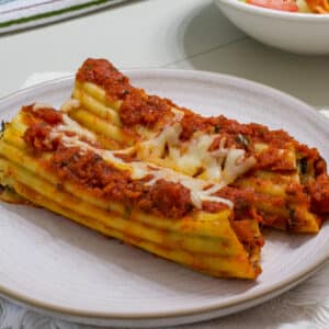 Two manicotti on a plate, this is the feature image.