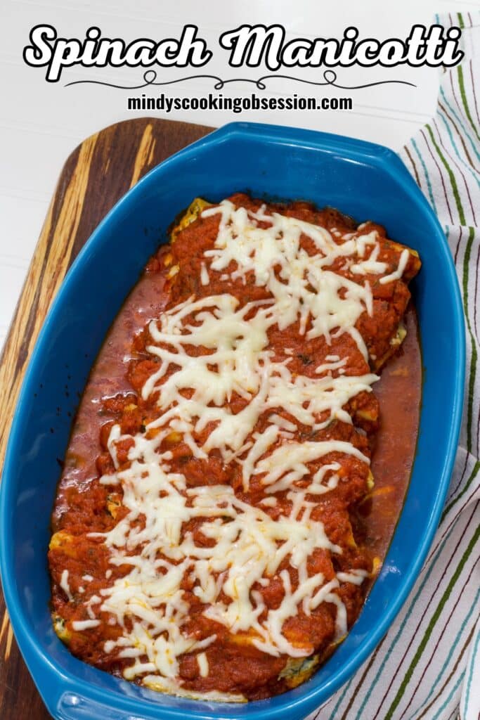 The casserole dish with Cheese & Spinach Stuffed Manicotti in it and the recipe title in text at the top.