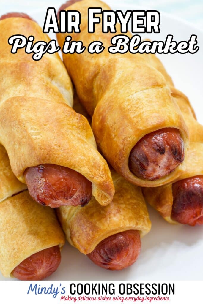 Five Air Fryer Pigs in a Blanket on a white plate with the recipe title in text at the top.