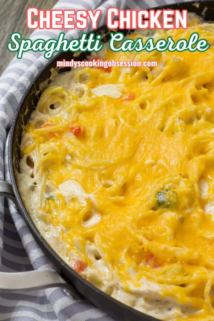 Half of the Cheesy Chicken Spaghetti Casserole is visible in a large skillet, after it came out of the oven.