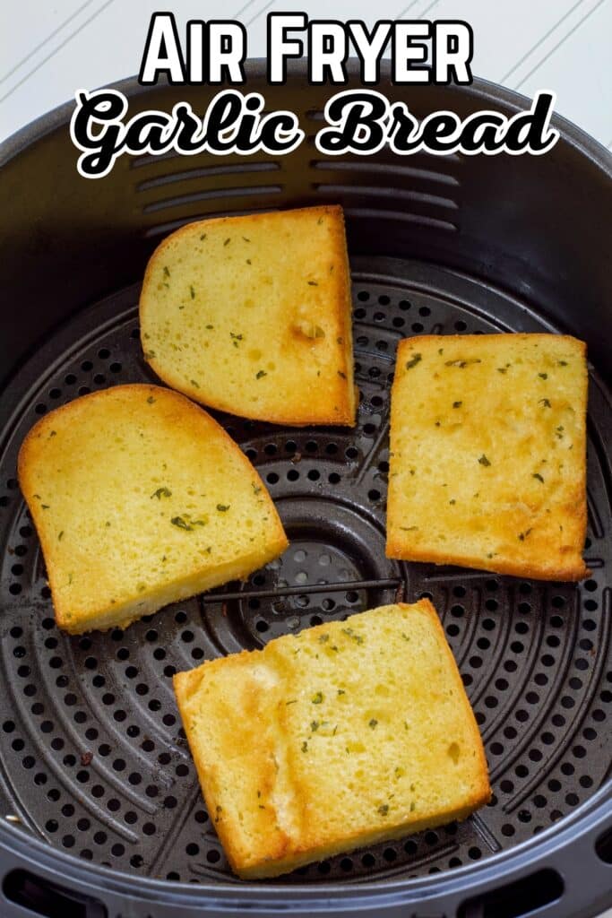 Four pieces of a loaf of garlic bread in the air fryer basket after they have been cooked, the post title is at the top.