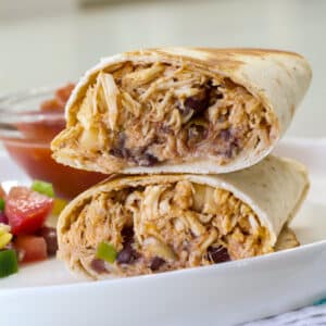 Very close angle of the cut Chicken and Black Bean Burrito exposing the insides.