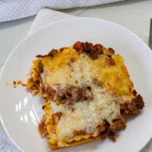 One serving of Easy Lazy Baked Ravioli Lasagna Casserole on a white plate.