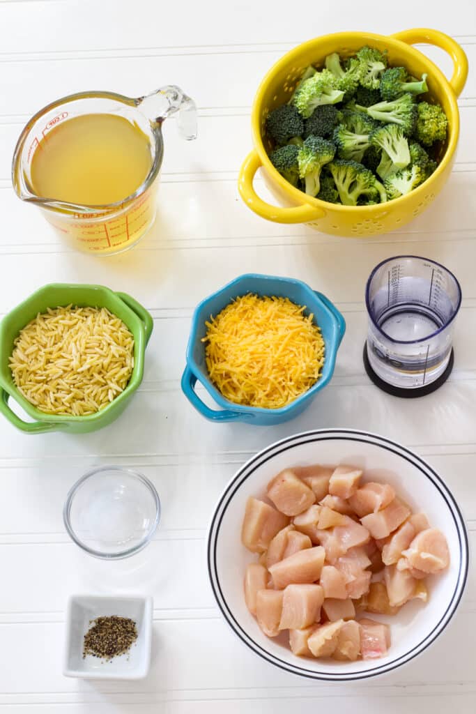 The chicken, chicken broth, broccoli, water, orzo, cheese, salt and pepper measured out to make this recipe.