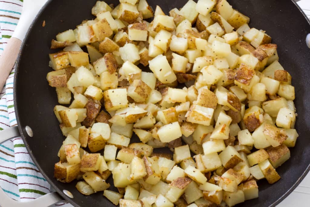 Overhead view of a nonstick skillet filled with Homemade Pan-Fried Potatoes.