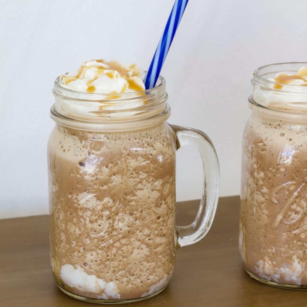 One whole glass and half of a glass full of Copycat Starbucks Salted Caramel Mocha Frappuccino.