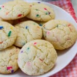 A white plate with several baked cookies on it.