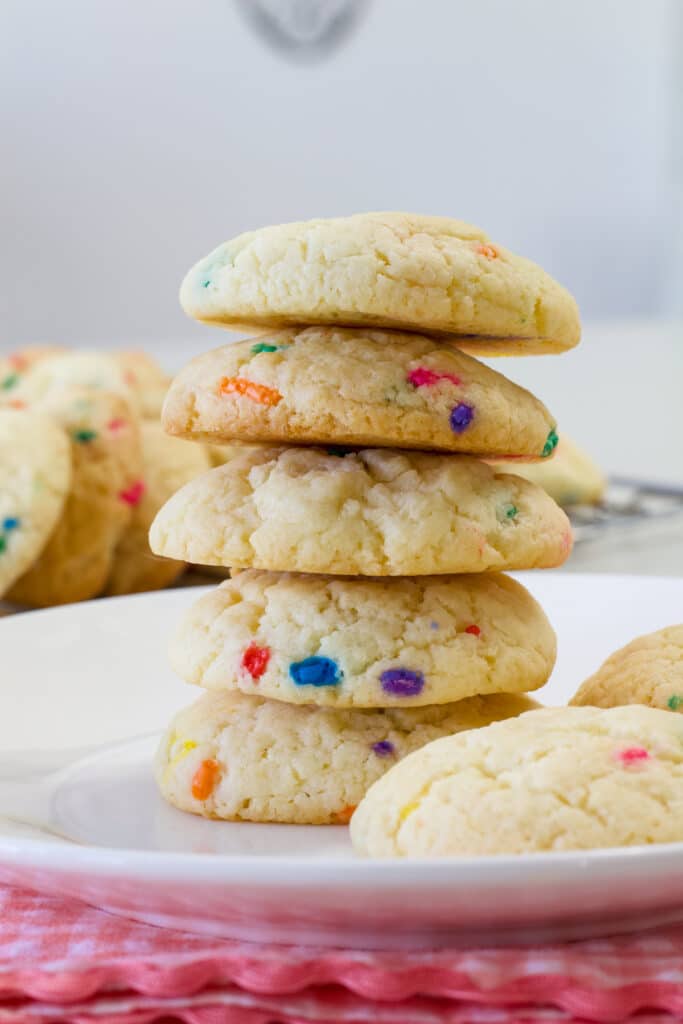 A stack of five baked confetti cookies that were made with a boxed cake mix.