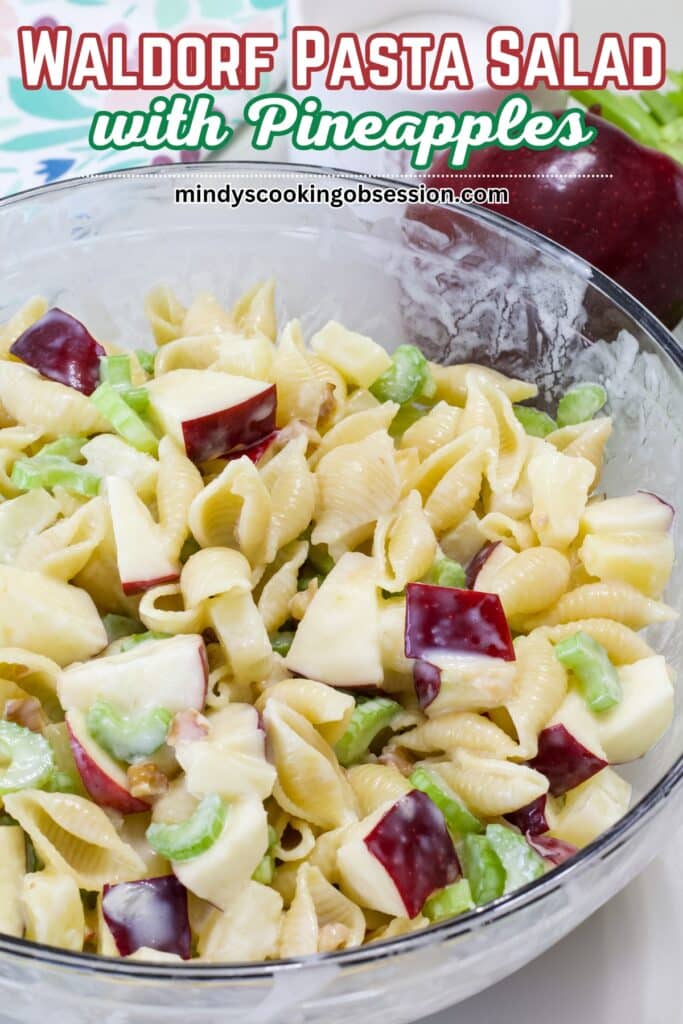 A large glass bowl of Waldorf Pasta Salad with Pineapple with the recipe title in text at the top.