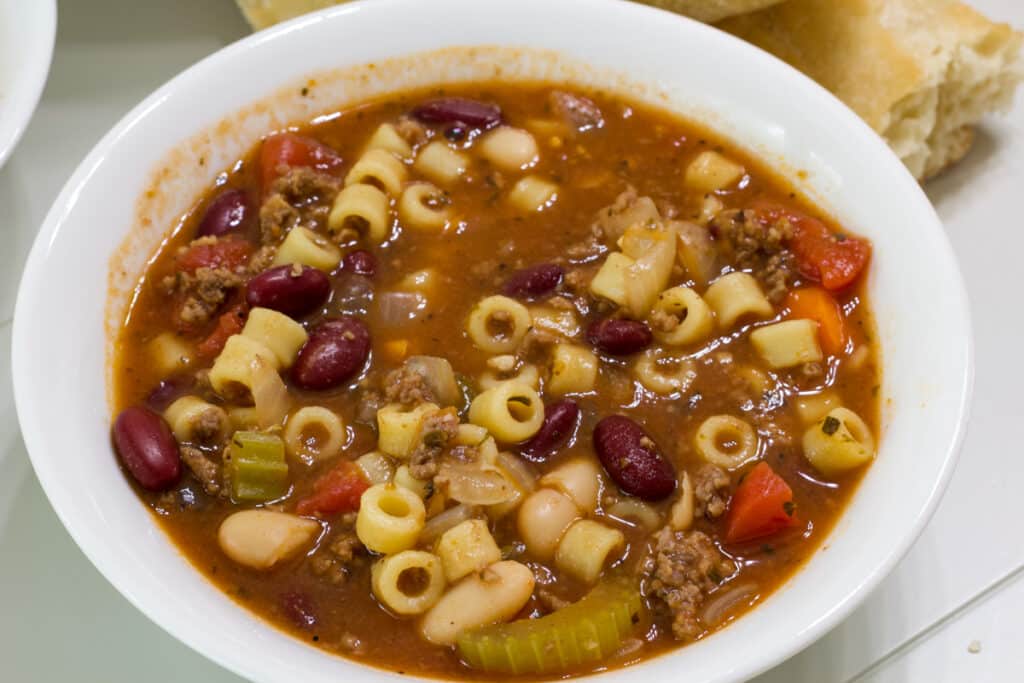 Close up of a bowl of Copycat Olive Garden Pasta e Fagioli soup.