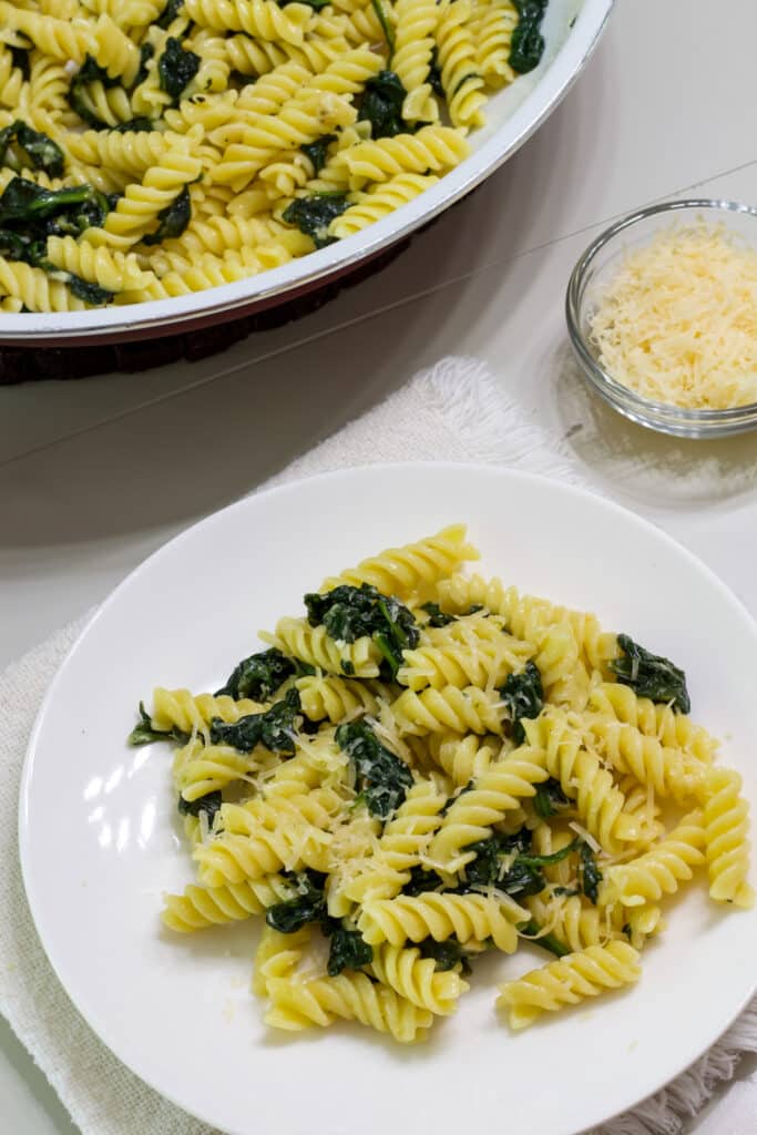 One serving of pasta and part of the pan with the remaining pasta.