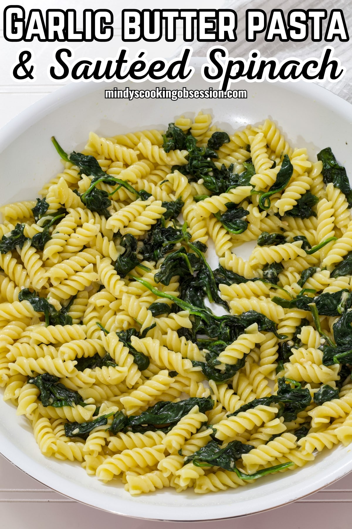 You are going to love this simple pasta dish because it is perfect for a quick and easy weeknight dinner. All you need is a handful of ingredients to make this easy spinach pasta recipe that is a great meatless meal or healthy and easy side dish. This versatile dish features tender pasta and fresh spinach tossed in an easy sauce made with a generous amount of Parmesan cheese, garlic, and milk. via @mindyscookingobsession