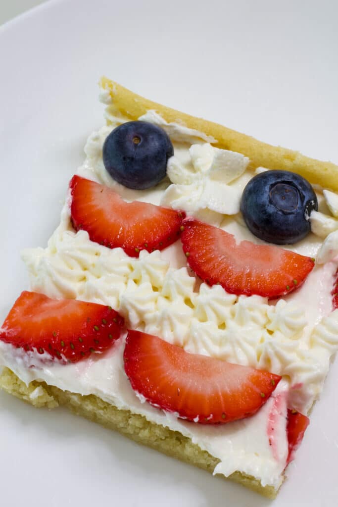 One serving of the patriotic fruit pizza on a white plate.