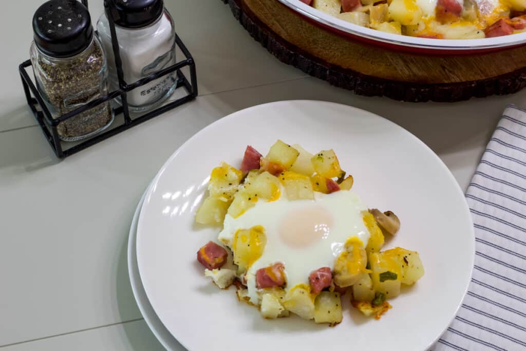 One serving of the Egg Ham Potato Breakfast Skillet on a white plate.