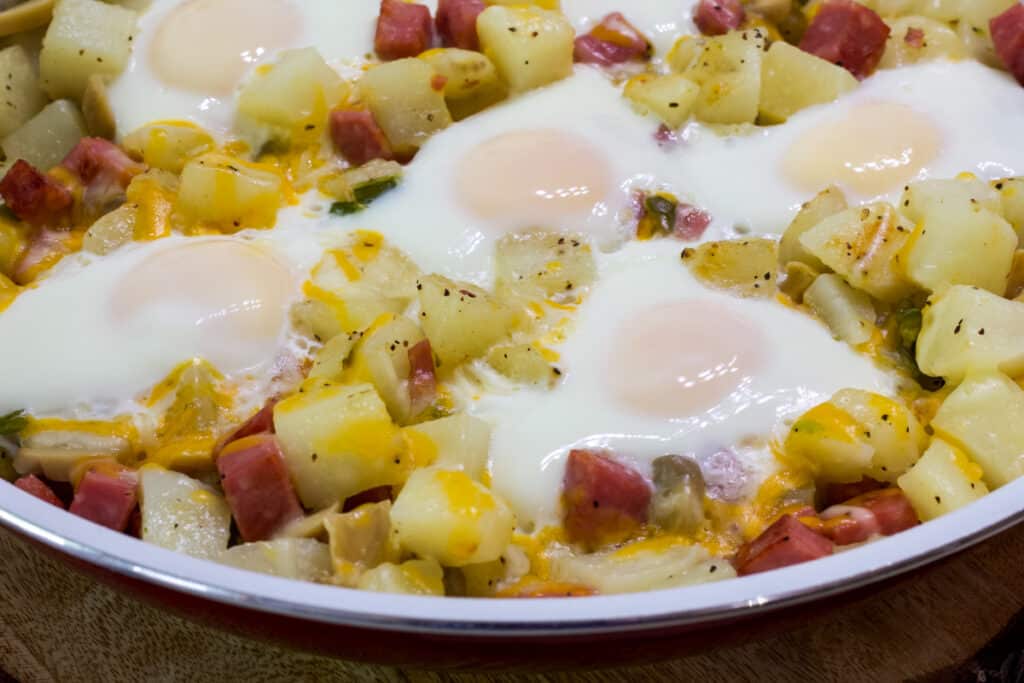 A close up of jus the front part of the skillet full of the finished Egg Ham Potato Breakfast Skillet.