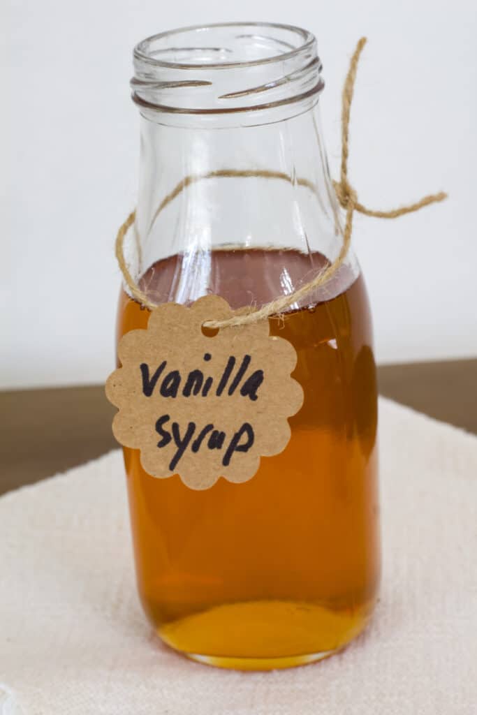 A small bottle filled with copycat Starbucks vanilla simple syrup for coffee.