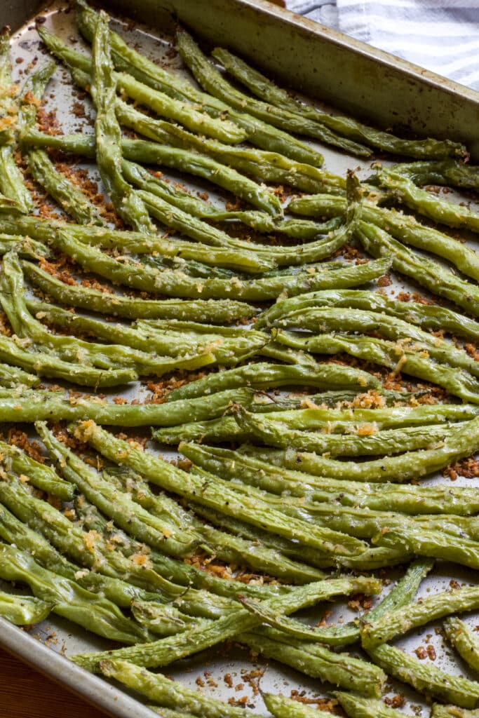 The Roasted Green Beans with Paremasan Cheese on a rimmed baking sheet after they came out of the oven.