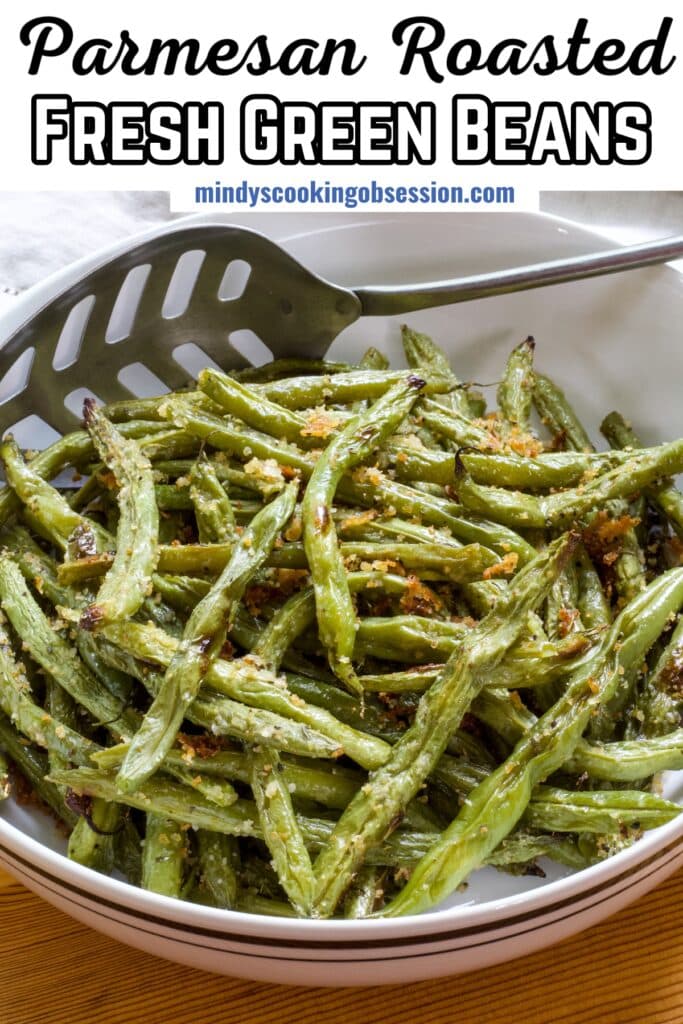 A large bowl with the Roasted Green Beans with Paremasan Cheese in it, the recipe title is in text at the top.