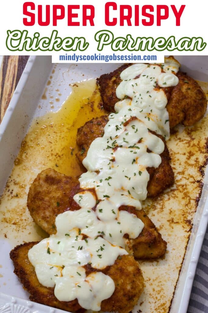 A pan full of Crispy Chicken Parmesan, the recipe title is in text at the top so it can be pinned on Pinterest.