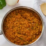 Overhead view of a stainless steel frying pan full of spanish rice.
