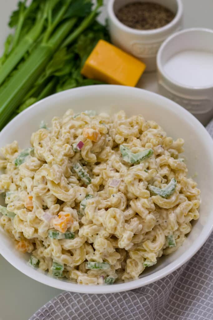 A serving bowl full of the finished Macaroni Pasta Salad with Cheddar Cheese.