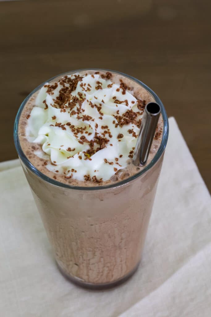 Overhead view of one glass of mocha frappuccino, the whole glass is visible.