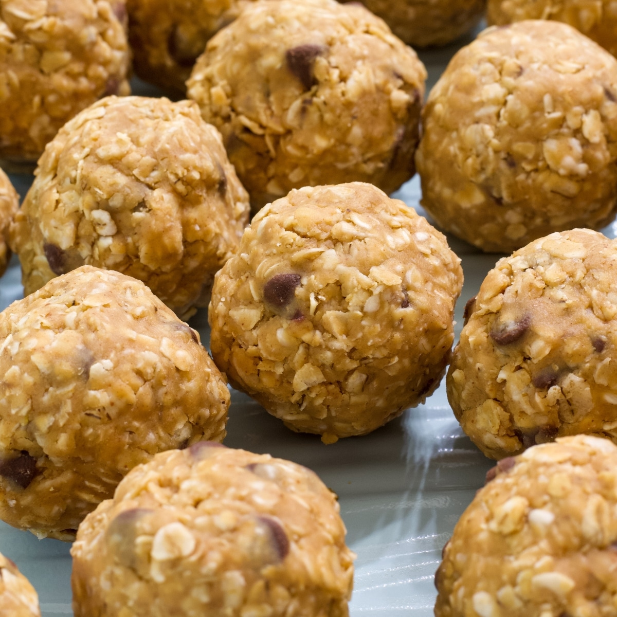 Several 4 Ingredient Protein Rich Peanut Butter Energy Balls on a sheet pan.