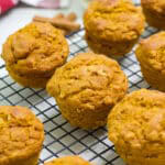 Feature image of several muffins on a wire rack cooling.