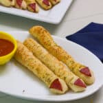 Feature image of three spooky witch finger snacks on a plate.