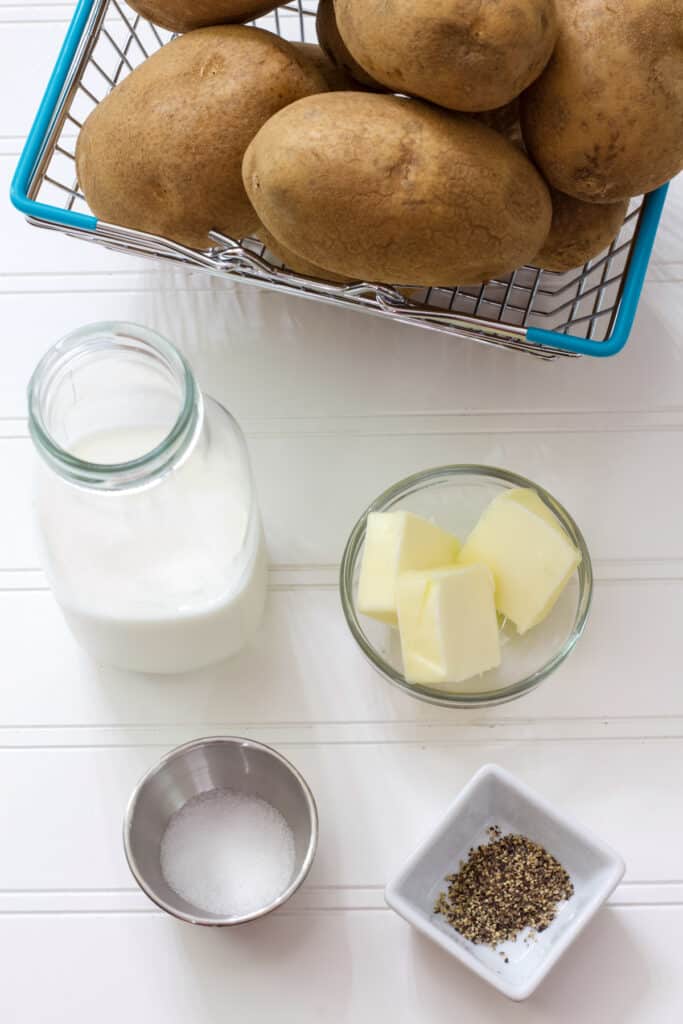 The potatoes, milk, butter, salt and pepper needed to Make Creamy Mashed Potatoes in Your KitchenAid Mixer.