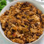 Feature image of a serving bowl full of Crockpot Mexican Chicken.
