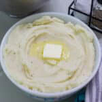Feature image of a bowl of mashed potatoes with a melting pat of butter in the center.