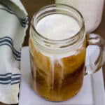 Feature image of the top view looking down on a mason jar mug of Starbucks Copycat Vanilla Sweet Cream Cold Brew.