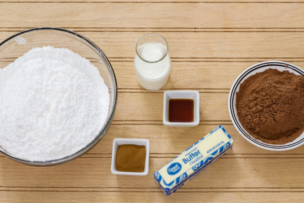 The powdered sugar, milk, cocoa powder, milk, vanilla and butter needed to make the Best Mocha Frosting Recipe.