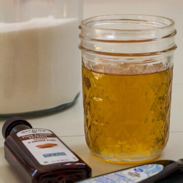 Feature image of the mason jar full of Copycat Starbucks Sugar Cookie Syrup.