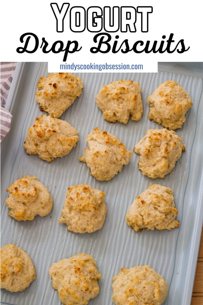 A sheet pan with baked biscuits on it, the recipe title is at the top in text so it can be pinned on Pinterest.