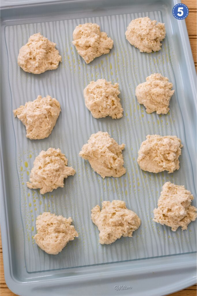 The biscuit dough dropped onto the baking sheet ready to go into the oven.