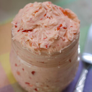Feature image of the the top of the small jar filled with Whipped Strawberry Honey Butter.
