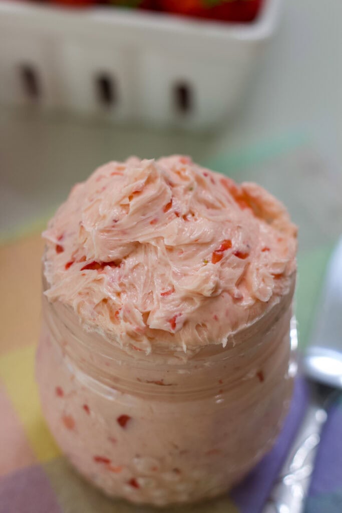 Angled view of the small mason jar filled with Whipped Strawberry Honey Butter.