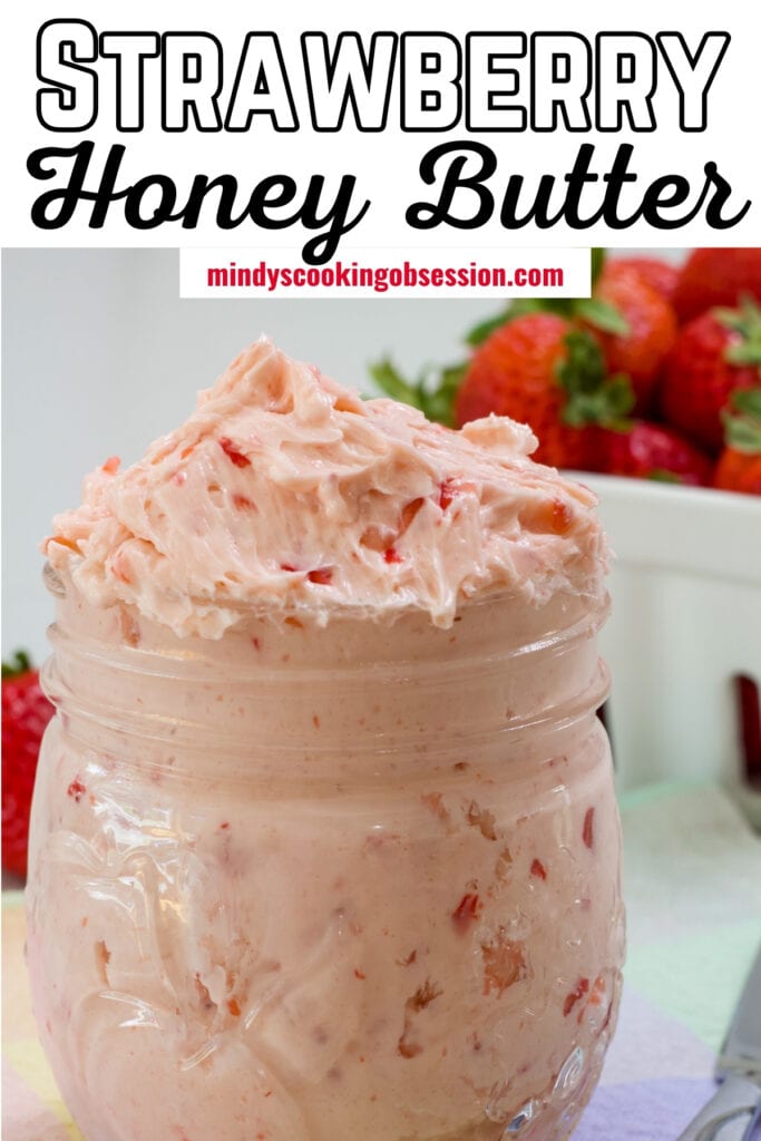 A mason jar filled with strawberry butter with the recipe title at the top so it can be pinned on Pinterest.