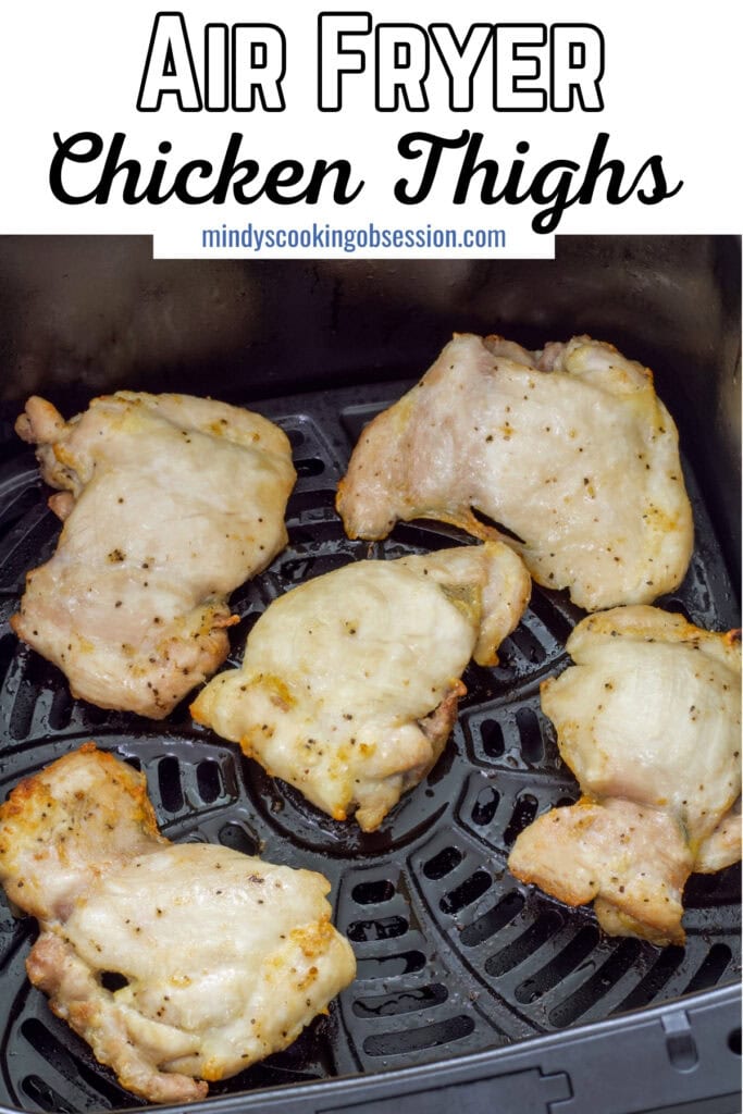 Air fried chicken thighs in the air fryer basket, the recipe title is at the top in text so it can be pinned on Pinterest.