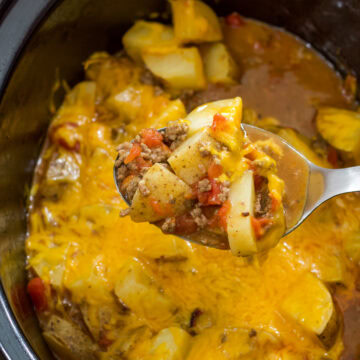 Feature image of a spoonful of the finished casserole over the crock with the remaining dish.