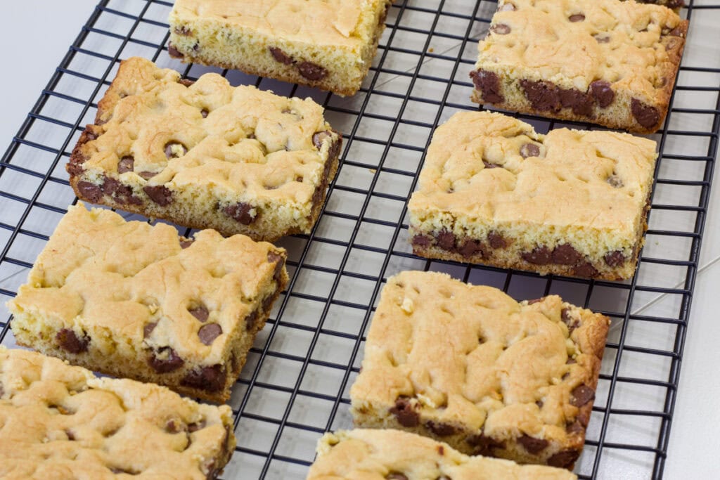 Eight cookie bars on a black wire cooling rack.