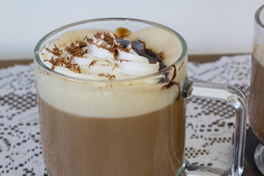 Side view of the top 2/3 of a glass mug with one Copycat Starbucks Tuxedo Mocha in it.