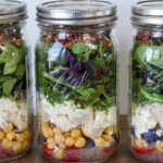 Feature image of a close up side view of the mason jar salad.