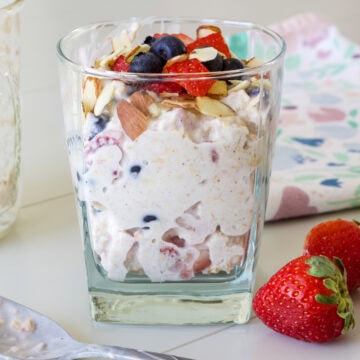 Feature image of the side view of the glass with a serving of Weight Watchers Berry Overnight Oats.